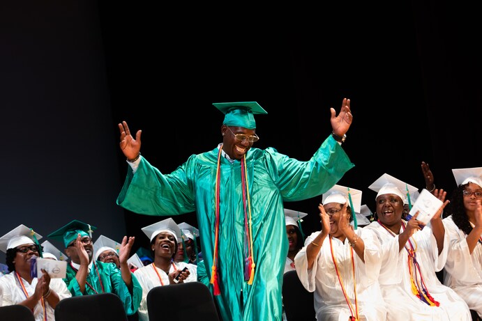 Stephen Corbin, 33, smiles as he walks across the stage to receive his diploma from the Goodwill Excel Center on July 19. (Sarah L. Voisin/The Washington Post)